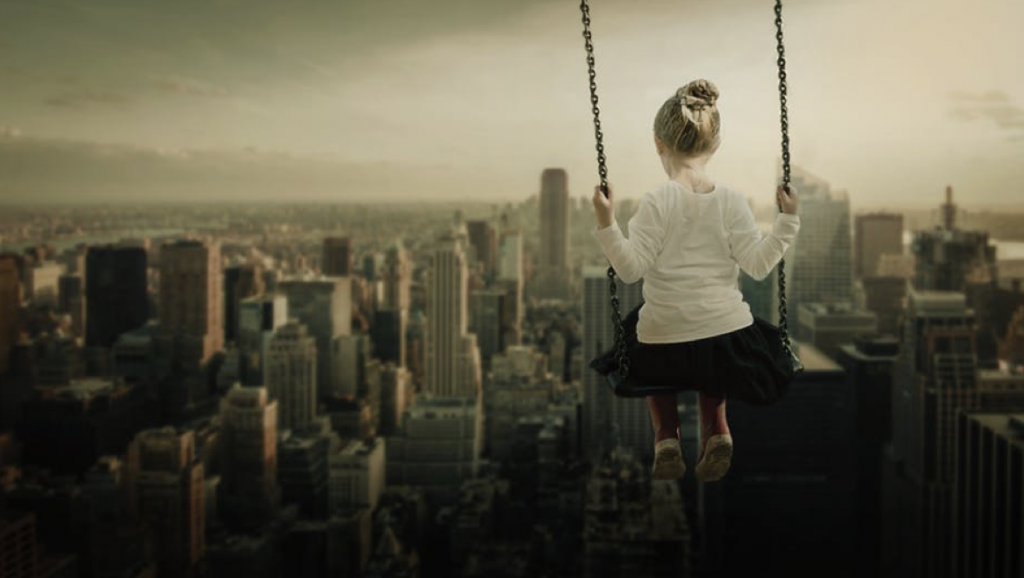 Girl on swing with city views