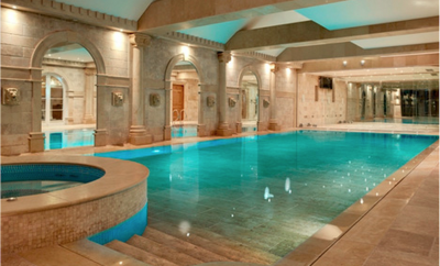 Indoor pool with light brown paving