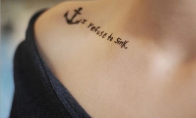 Woman with a word tattoo on her collar bone