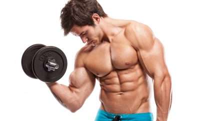 Ripped young man lifting weights