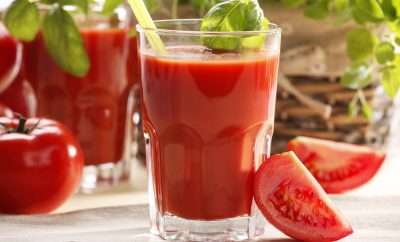 Glasses of tomato juice and celery sticks