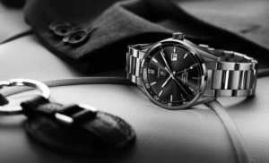 Black and white picture of a designer watches and car keys on a