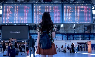 Woman looking at the airport boarding times