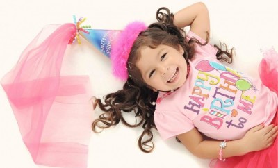 3 year girl dressed in pink top and pink tutu with a fairy hat