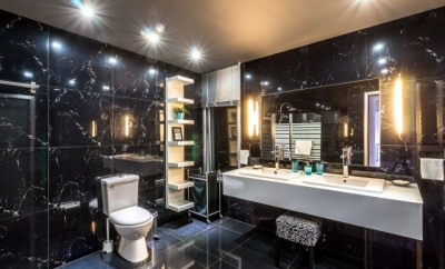 large modern bathroom with black wall to wall granite
