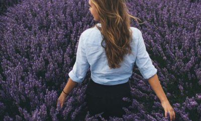 Back shot of a woman walking in a lavender field