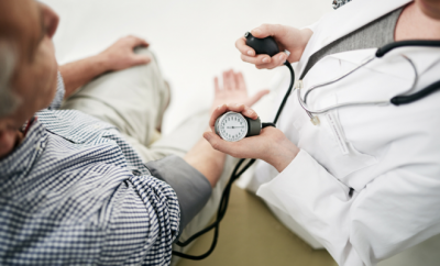 doctor taking patient blood pressure