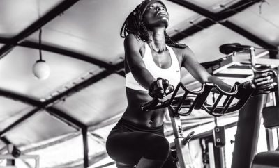 black and white woman in a gym bike exercising