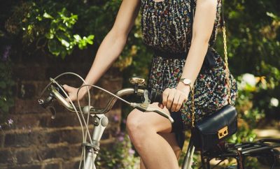 girl in a bicycle in a patterned dress