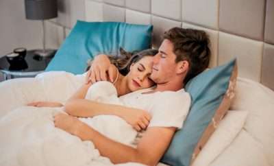 Couple in bed hugging