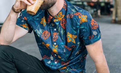 headless shot of a men drinking coffee in a fashion shirt
