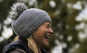 woman wearing a beanie smiling