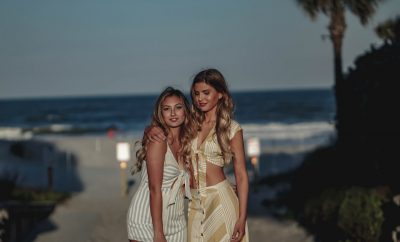 2 blond women, beach, night time