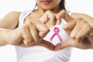 woman with breast cancer pink sign