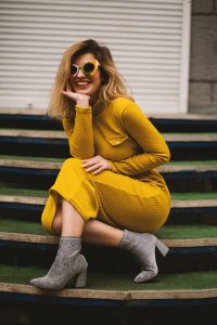 woman in along yellow dress on stairs