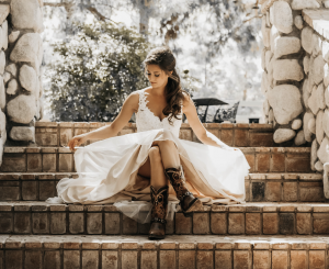 woman in white dress sitting on stone stairs
