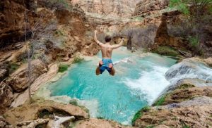 Man diving into a natural pool
