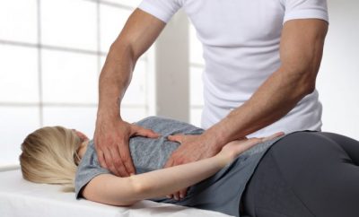 Chiropractor treating a lady