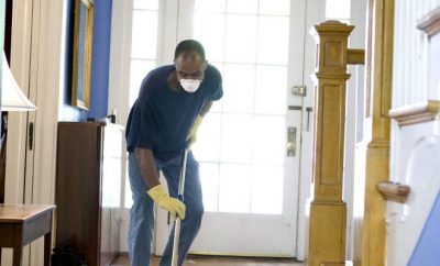 man wearing a mask while cleaning