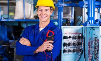 Young electrician smiling at the camera