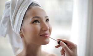 young woman with hoar towel, makeup