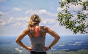 woman looking down a hill after exercise