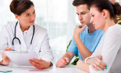Doctor in consultation with a couple