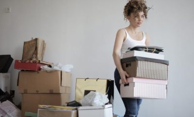 woman carrying boxes to move