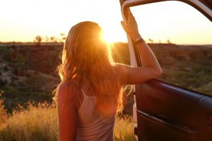 woman on a road trip, sunset,