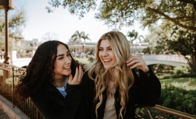 two young women laughing at the park