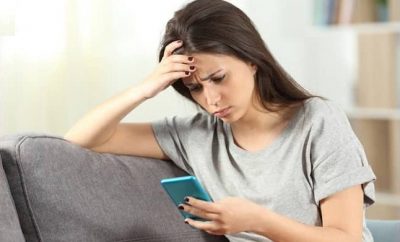 Woman looking at her mobile phone, social media detox