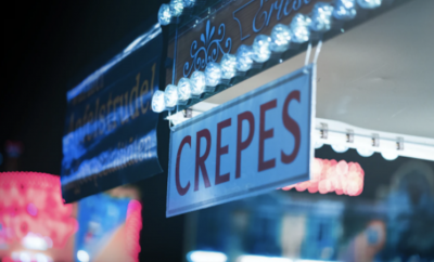 A sign with the word 'crêpe'
