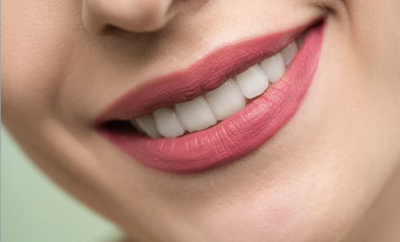 Woman with pink lipstick and smiling