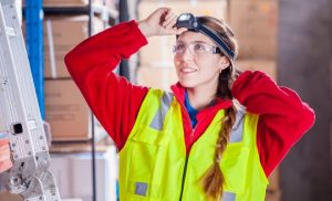 Woman wearing safety glasses at work