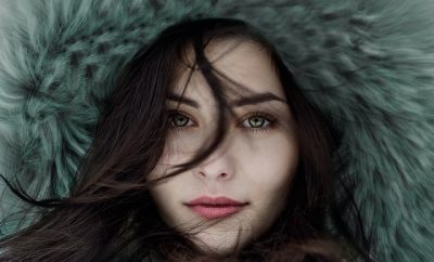 Young woman with a fluffy hat looking at the camera