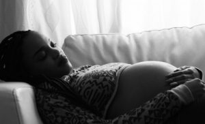 Pregnant woman lying in the couch