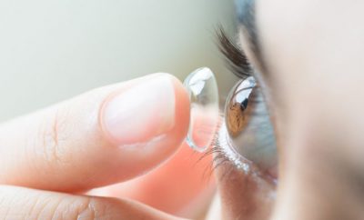 Lady putting on contact lenses