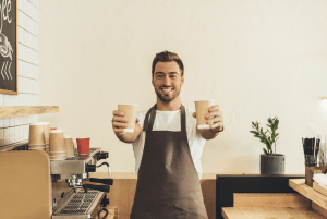 Man offering 2 cups of coffee