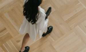Lady walking on parquetry floor