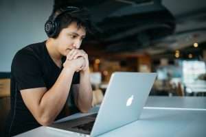 Student with headphones online learning
