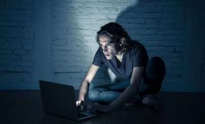 Man looking at his laptop in the dark
