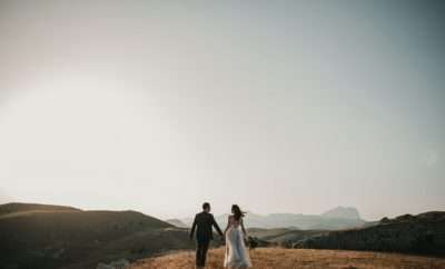 Bride and groom walking into the sunset