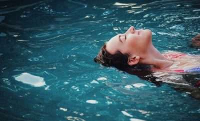 Woman floating on her back in the pool
