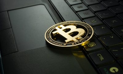 Bitcoin coin on top of a laptop