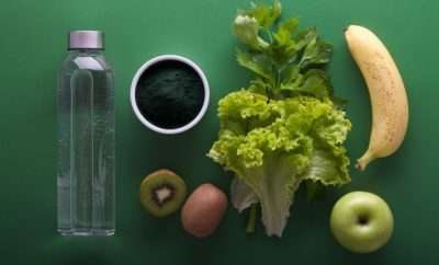 Bottle of water, green vegetables and fruit