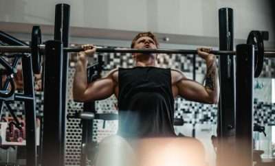 Man at gym in a pull up bar