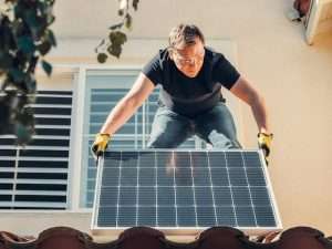 Man laying a solar panel