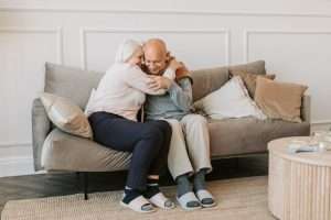 Retired couple embracing in the couch