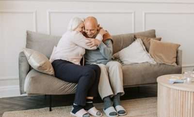 Retired couple embracing in the couch