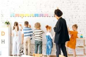 Teacher and kids at the whiteboard